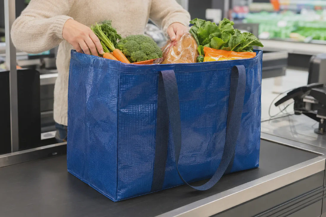 Reusable woven shopping bag carrying groceries