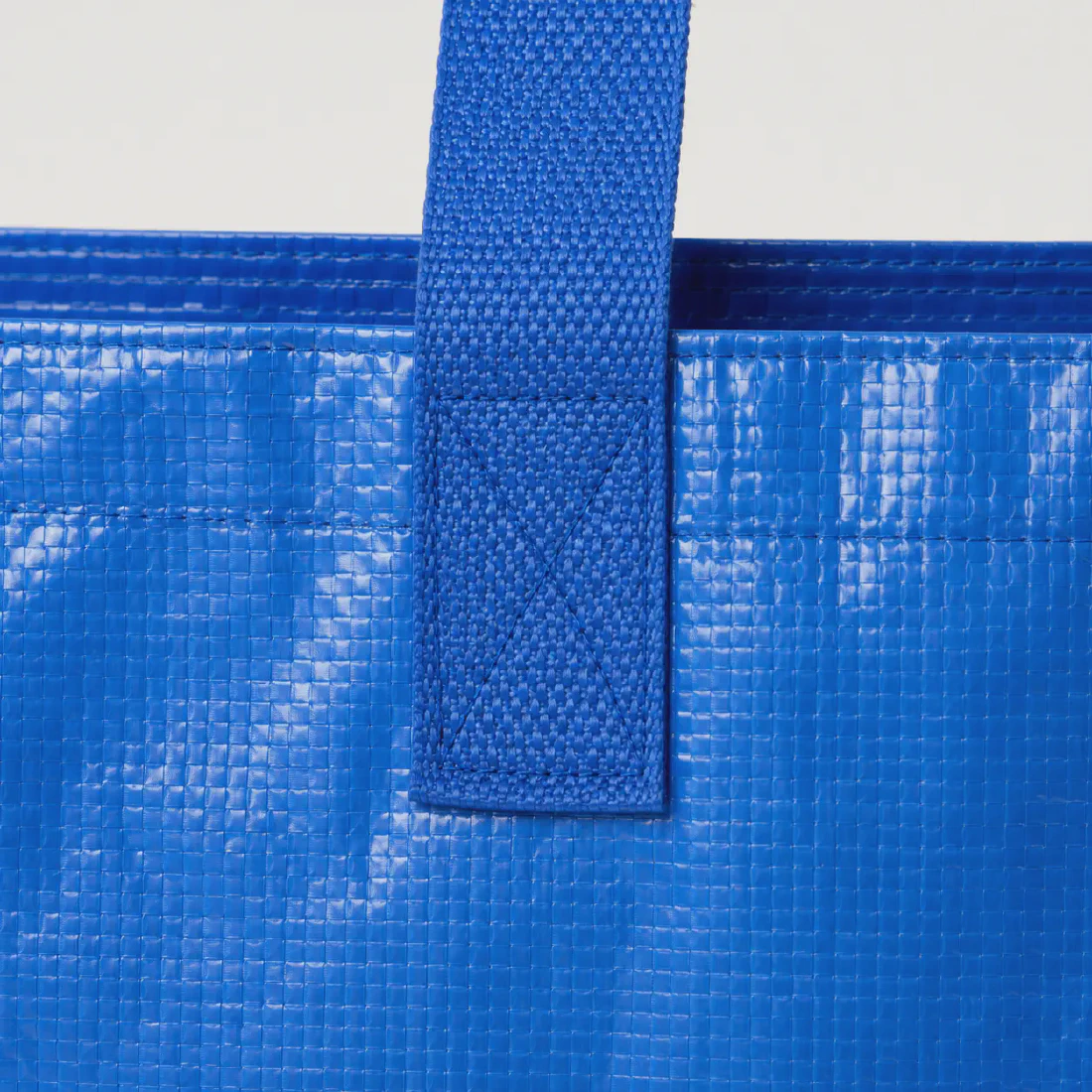 Close-up of the reinforced blue webbing handle attachment